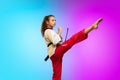 Karate, taekwondo girl with black belt isolated on gradient background in neon light
