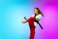 Karate, taekwondo girl with black belt isolated on gradient background in neon light