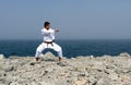 Karate trains on the shores of sea Royalty Free Stock Photo