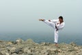 Karate trains on the shores of the sea Royalty Free Stock Photo