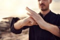 Karate, welcome or hands of zen man with peaceful, calm or mindfulness in nature at a beach for meditation. Fitness Royalty Free Stock Photo