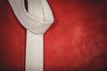 Karate white belt on red background