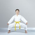 In karategi, a small sportswoman stands in the rack