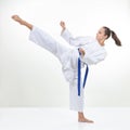 In karategi the sportswoman beats a high kick leg