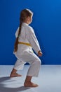 In karategi the sportswoman stands in a karate rack