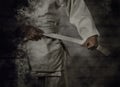 Karateka tying the white belt (obi) with grunge background