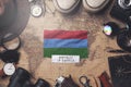 Karelia Flag Between Traveler`s Accessories on Old Vintage Map. Overhead Shot