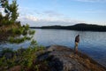 Karelia, Russia - Jule, 2021: A fisherman catches fish on the shores of Lake Ladoga