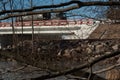 View of the road bridge through the branches of blooming alder Royalty Free Stock Photo