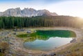 Karersee or Lago di Carezza, is a lake with mountain range of the Latemar group on background in the Dolomites in Tyrol