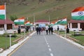 Indian tricolor national flag flying in front the Dwars memorial or Kargil War Memorial Tourist heading towards gate Royalty Free Stock Photo