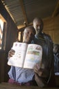 Karimba School with school children holding up their textbook in classroom in North Kenya, Africa