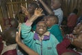 Karimba School with school children raising their hands in classroom in North Kenya, Africa