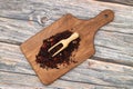 Karkade tea. Hibiscus tea leaves in wooden scoop isolated on wooden background. File contains clipping path. Top view