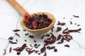 Karkade tea. Hibiscus tea leaves in wooden spoon isolated on white background. File contains clipping path. Top view
