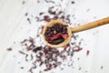 Karkade tea. Hibiscus tea leaves in wooden spoon isolated on white background. File contains clipping path. Top view