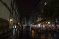 Karlova street by night with tourists passing by. The street, paved with cobblestone, is an iconic landmark of the city center Royalty Free Stock Photo