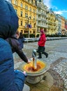Karlovy Vary, Cszech Republic - January 01, 2018: The man drinks water from a hot thermal spring in Karlovy Vary, Czech Royalty Free Stock Photo
