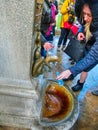 Karlovy Vary, Cszech Republic - January 01, 2018: The woman drinks water from a hot thermal spring in Karlovy Vary Royalty Free Stock Photo