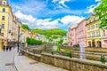 Karlovy Vary, Czech Republic, May 10, 2019: people are walking down street and Tepla river embankment Royalty Free Stock Photo