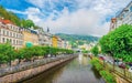 Karlovy Vary historical city centre with Tepla river pedestrian embankment, colorful beautiful buildings Royalty Free Stock Photo