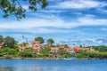 KARLSKRONA, SWEDEN - 2017 July. Typical red Swedish wooden houses with natiaonal flag in the city of Karlskrona Royalty Free Stock Photo