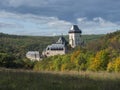 Karlstejn gothic state castle near Prague, the most famous castle in Czech Republic with grass meadow and autumn colored trees and