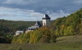 Karlstejn gothic state castle near Prague, the most famous castle in Czech Republic with grass meadow and autumn colored trees and