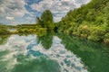 Karlstrup Kalkgrav is a lake that formed in an old quarry housing a small heaven as clouds and vegetation reflect in the water