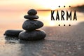 Karma concept. Stones on sand near sea at sunset