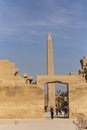 Karnak Temple, complex of Amun-Re. Embossed hieroglyphics on columns and walls. Tourists visiting the sights. Royalty Free Stock Photo