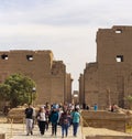 Karnak Temple, complex of Amun-Re. Embossed hieroglyphics on columns and walls. Tourists visiting the sights Royalty Free Stock Photo