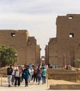 Karnak Temple, complex of Amun-Re. Embossed hieroglyphics on columns and walls. Tourists visiting the sights Royalty Free Stock Photo
