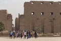 Karnak Temple, complex of Amun-Re. Embossed hieroglyphics on columns and walls. Tourists visiting the sights Royalty Free Stock Photo