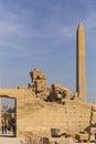 Karnak Temple, complex of Amun-Re. Embossed hieroglyphics on columns and walls. Tourists visiting the sights. The Obelisk Of Hatsh Royalty Free Stock Photo