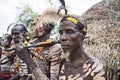 Several men from the Caro tribe pose in front of the camera for a group photo.