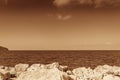 Rocky shore on Karpathos Island in sepia Royalty Free Stock Photo