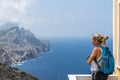 Tourist admiring Karpathos Island stunning coastal landscape