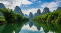 Karst mountains and bamboo forest reflected in a calm river under a cloudy sky limestone peaks Royalty Free Stock Photo
