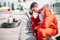 Karting racer sits on a tire, outdoor kart track