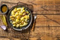 Kartoffelsalat - Traditional German potato salad. Wooden background. Top view. Copy space