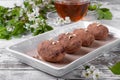 Kartoshka cake on the ceramic platter and a cup of tea Royalty Free Stock Photo