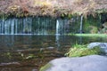 Karuizawa Shiraito waterfalls peaceful natural area featuring a small arc-shaped waterfall framed by mountain slopes
