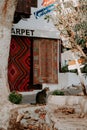 A cat sitting in frond of Turkish carpet store, carpet bazaar in Kas, Turkey