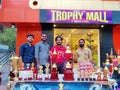 Some young peoples and Trophies display. Picture taken from a trophy shop