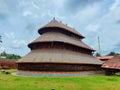 Adoor Temple ancient Kerala architecture view under the sky. Beautiful design temple carvings surrounded by green grasses