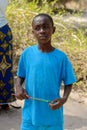 Unidentified Diola boy in blue shirt looks away in Kaschouane v