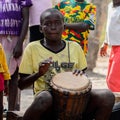 Unidentified Diola boy plays on drums in Kaschouane village. Di