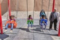 Iranian children swing on swing in park, Kashan, Iran.