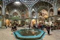 Group of tourists resting in the Aminoddole Caravanserai of Grand Bazaar of Kashan, Iran